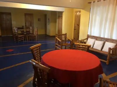 a dining room with a red table and chairs at La Cueva del Che in Juan Dolio