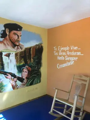 a mural in a room with a painting on the wall at La Cueva del Che in Juan Dolio