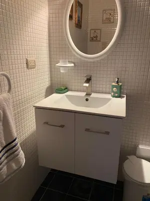 a bathroom with a white sink and a mirror at Apartamento Juan Dolio in Juan Dolio