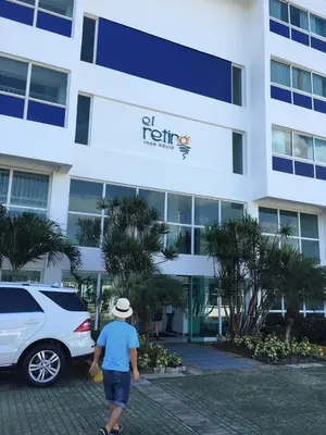 a man walking in front of a hotel at Apartamento Juan Dolio in Juan Dolio
