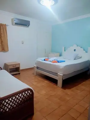 a bedroom with two beds in a room at Hotel Kevin in San Felipe de Puerto Plata