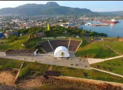 an aerial view of a building on a hill next to a body of water at Hotel Kevin in San Felipe de Puerto Plata
