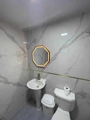 a bathroom with a sink and a toilet and a mirror at Mar azul 401 in San Felipe de Puerto Plata