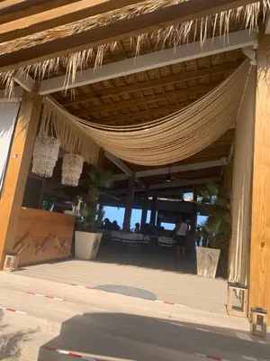 a resort with a hammock on the beach at Mar azul 401 in San Felipe de Puerto Plata