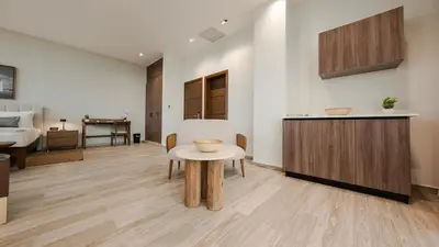 a living room with a table and a bed at Mauad Hotel Boutique in Santo Domingo