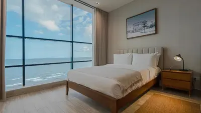 a bedroom with a bed with a view of the ocean at Mauad Hotel Boutique in Santo Domingo