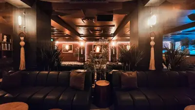 a living room with couches and plants and lights at Mauad Hotel Boutique in Santo Domingo