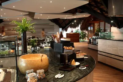 a restaurant with a counter with food on it at Casa de Campo Resort & Villas in La Romana