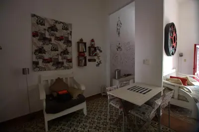 a room with a table and a table and chairs at La Puerta Roja Guest House in Santo Domingo