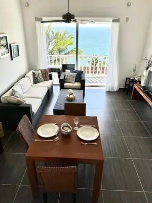 a living room with a couch and a table at Spectacular Ocean View Top Floor 1-Bedroom Condo, Vista Mare, Samana DR in Santa Bárbara de Samaná