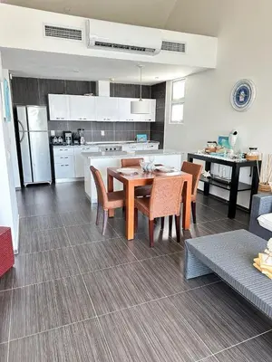 a kitchen and dining room with a table and chairs at Spectacular Ocean View Top Floor 1-Bedroom Condo, Vista Mare, Samana DR in Santa Bárbara de Samaná