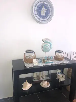 a shelf with a blue and white plate and some items at Spectacular Ocean View Top Floor 1-Bedroom Condo, Vista Mare, Samana DR in Santa Bárbara de Samaná