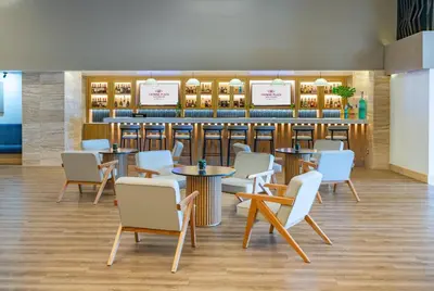 a restaurant with tables and chairs and a bar at Crowne Plaza Santo Domingo by IHG in Santo Domingo