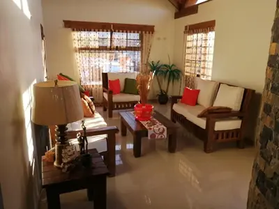 a living room with couches and chairs and a table at Villa Laura Jarabacoa in Jarabacoa