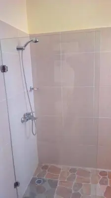 a shower with a glass door in a bathroom at Casa D9 in Santo Domingo