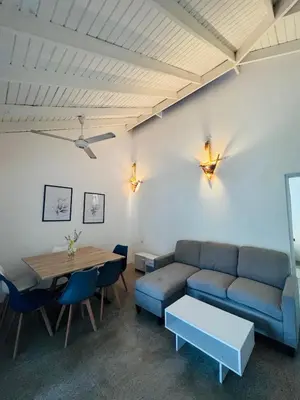 a living room with a couch and a table at Hotel Casa Pierretta in Las Terrenas