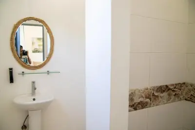 a bathroom with a sink and a mirror at Hotel Casa Pierretta in Las Terrenas