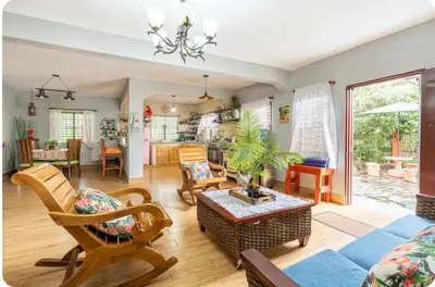 a living room with a couch and a table at Cabaña Don Tobo Jarabacoa RD in Jarabacoa