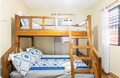 a bunk bed room with two bunk beds at Cabaña Don Tobo Jarabacoa RD in Jarabacoa