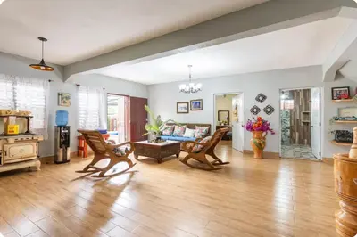 a living room with a couch and a table at Cabaña Don Tobo Jarabacoa RD in Jarabacoa