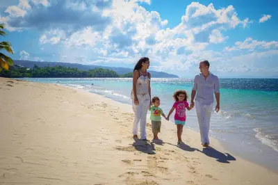 a family walking on the beach at Hotel Playa Colibri in Las Terrenas