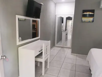 a bedroom with a white desk and a bed at Hotel Cambri in Nagua