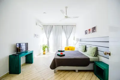 a bedroom with a bed and a television in it at Terraza Art Villa Dominicana in Punta Cana