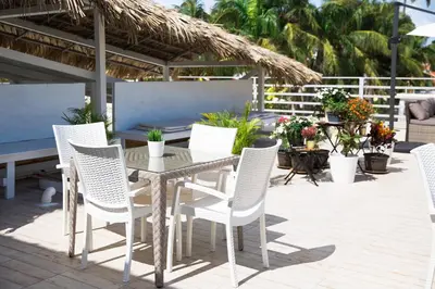 a patio with a table and chairs on a patio at Terraza Art Villa Dominicana in Punta Cana