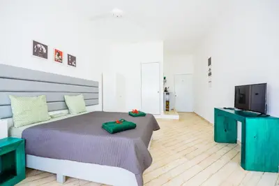 a bedroom with a bed and a flat screen tv at Terraza Art Villa Dominicana in Punta Cana
