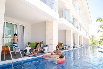 a group of people in the swimming pool at a hotel at Nickelodeon Hotels & Resorts Punta Cana - Gourmet All Inclusive by Karisma in Punta Cana