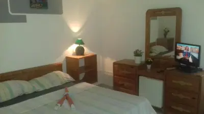 a bedroom with a bed and a dresser and a mirror at Casa Picadilly in Boca Chica