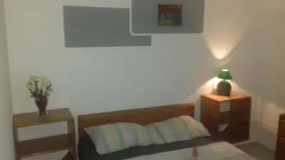 a bedroom with a bed and two night stands at Casa Picadilly in Boca Chica