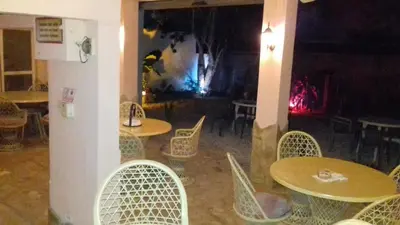 a group of tables and chairs in a restaurant at Casa Picadilly in Boca Chica