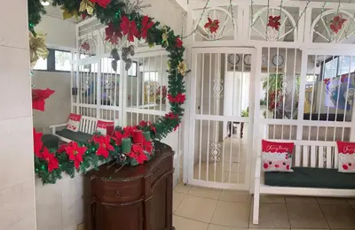 a living room with christmas decorations on the walls at Royal Palace Hotel in Santo Domingo