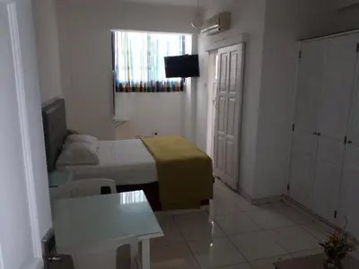 a bedroom with a bed and a table and a window at Royal Palace Hotel in Santo Domingo