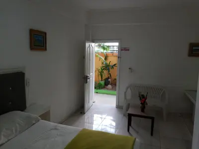 a bedroom with a bed and a door to a yard at Royal Palace Hotel in Santo Domingo