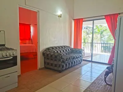 a living room with a couch and a bedroom at Perla de Sosua in Sosúa