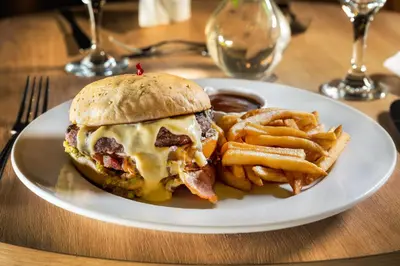 a plate with a sandwich and french fries on a table at Coral Costa Caribe Beach Resort - All Inclusive in Juan Dolio