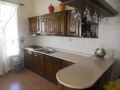 a kitchen with wooden cabinets and a counter top at Apartamento Frente Al Mar in San Felipe de Puerto Plata