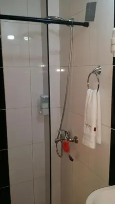 a bathroom with a shower with a towel hanging on the wall at Apartamento Frente Al Mar in San Felipe de Puerto Plata