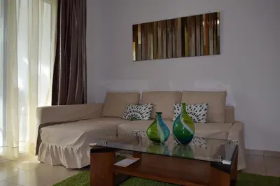 two green vases sitting on a coffee table in a living room at Comfortable Apartment in Caribbean Paradise in Sosúa
