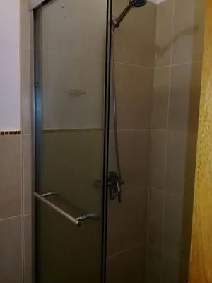 a shower with a glass door in a bathroom at Comfortable Apartment in Caribbean Paradise in Sosúa