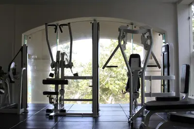 a gym with several tread machines in front of a window at Casa Colonial Beach & Spa in San Felipe de Puerto Plata