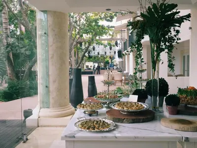 a table with several trays of food on it at Casa Colonial Beach & Spa in San Felipe de Puerto Plata