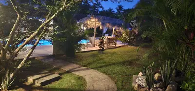 a resort with a gazebo and a pool at night at Casa Giò in Las Terrenas