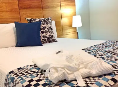 a hotel room with a bed with towels on it at Hotel Aladino in Santo Domingo