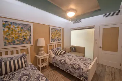 a bedroom with two beds and a lamp at Juan Dolio Costa del Sol in Juan Dolio