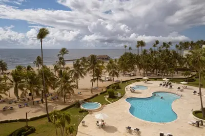 an aerial view of a resort with a swimming pool and the beach at Juan Dolio Costa del Sol in Juan Dolio