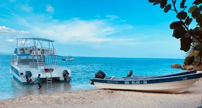 two boats on the shore of a beach at Hotel Sand Bay in Punta Rucia