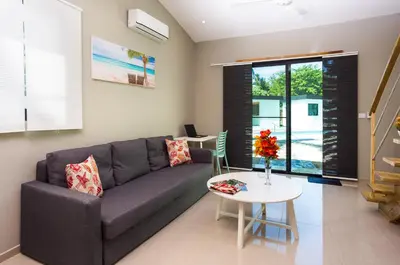 a living room with a couch and a table at Residence Las Dos Palmas in Las Terrenas